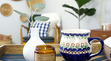 Serving tray with a vase, mug and candle