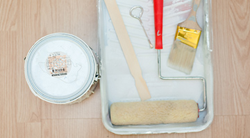 Gallon cans of BEHR PREMIUM PLUS paint and KILZ ORIGINAL primer