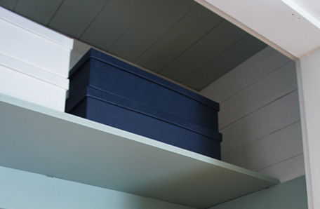 Cut the top shelf shorter to give yourself access