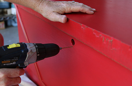 Drill pilot holes for the new lock mechanism