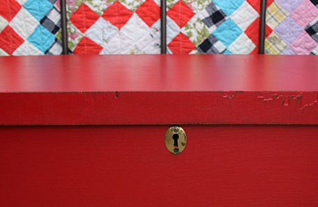 Opened chest with several blankets tucked away in storage