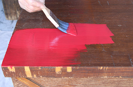 Putting on the first coat of paint on the chest top