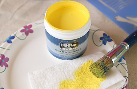 Use a paper towel to dry off your stencil brush before applying it to the dresser