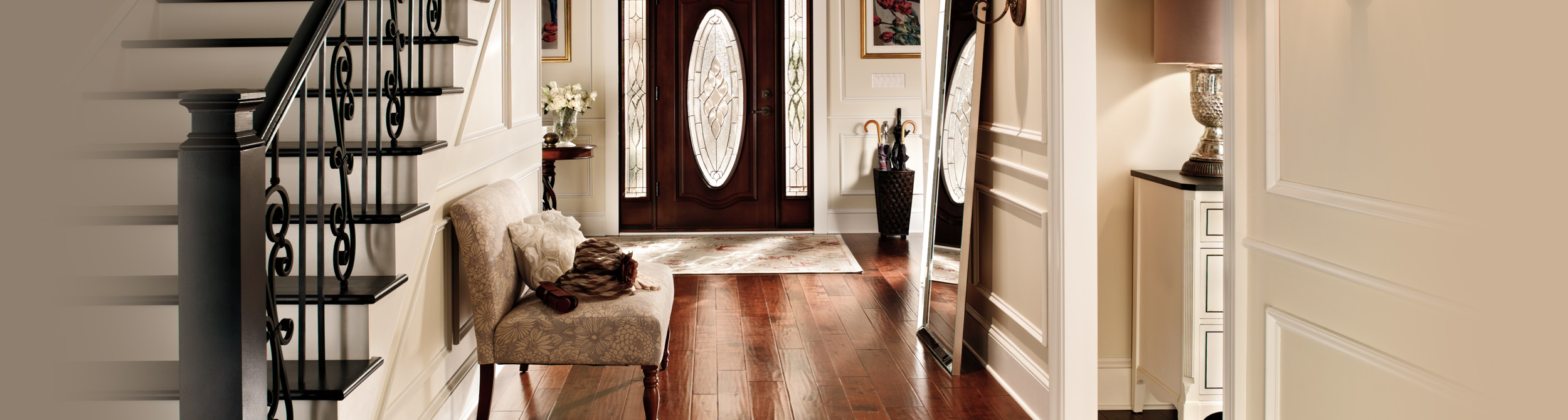 Hallway with stairs inspiration with white walls, white trim, wooden door.
