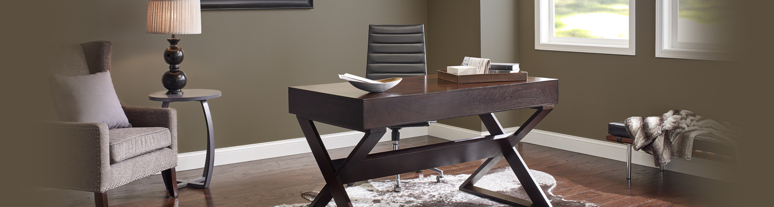 Inspiration office workspace with brown walls and white trim, wooden desk.