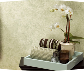 Hand towels, a candle, and flowers on a table