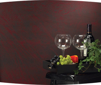 A bottle of wine, two glasses, and fruit sitting on a table